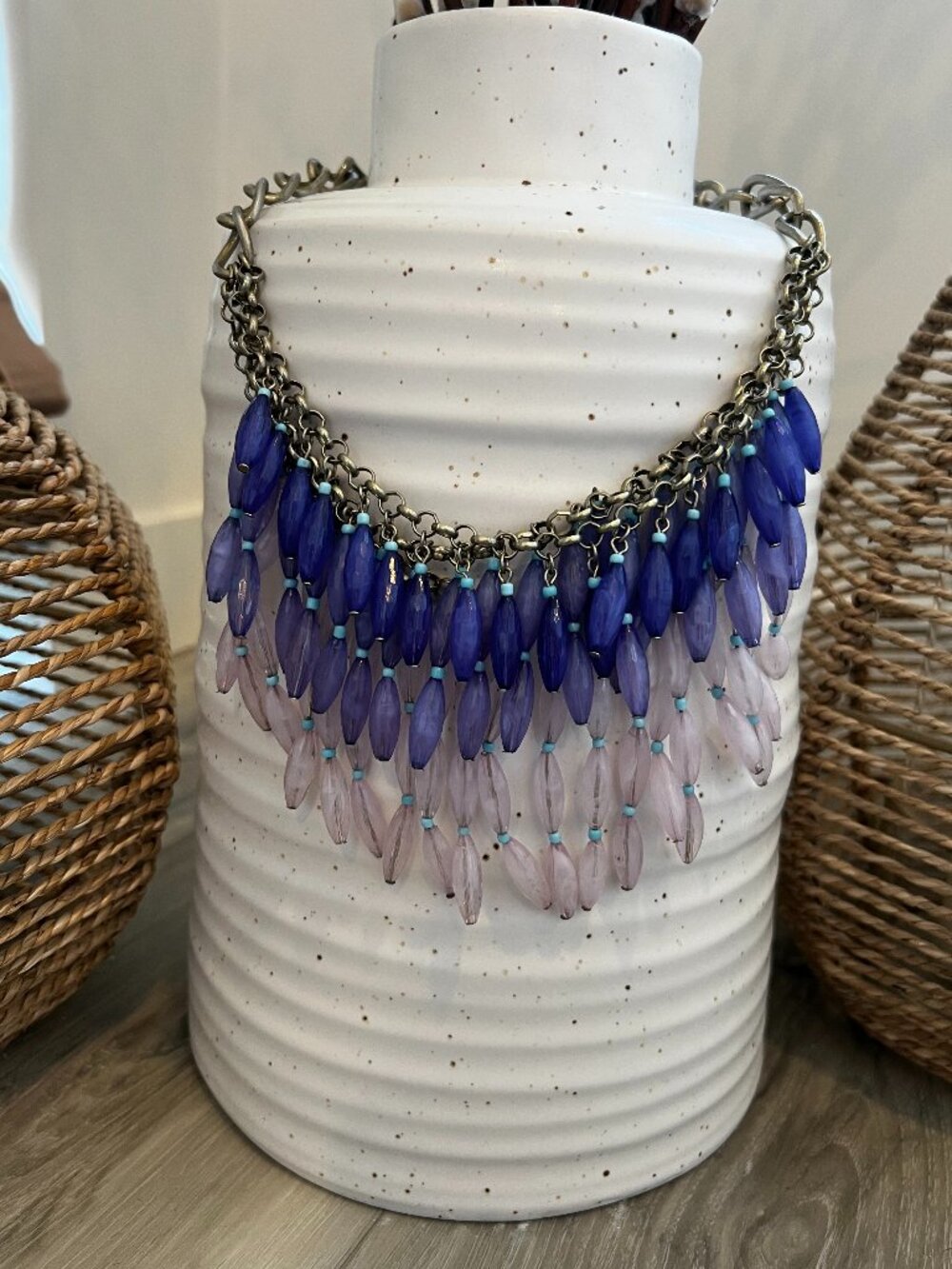 Anthropologie waterfall necklace with layers of blue beads on brass chain